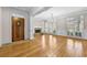 Spacious living room features hardwood floors, a stone fireplace, and elegant chandelier lighting at 4782 Lakeway, Alpharetta, GA 30005