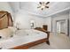 Well-lit main bedroom boasts a tray ceiling, fan, neutral walls, and easy access to the ensuite at 4782 Lakeway, Alpharetta, GA 30005