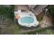 Aerial view of a backyard with a luxurious pool, hot tub, manicured landscaping, and firepit at 4981 Millwood Dr, Canton, GA 30114