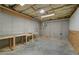Spacious unfinished basement area with concrete walls and floors and exposed ceiling at 4981 Millwood Dr, Canton, GA 30114