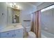 Tiled bathroom featuring a vanity, toilet, and shower with curtain at 4981 Millwood Dr, Canton, GA 30114