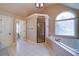 Bright bathroom featuring a glass enclosed shower, soaking tub under an arched window, and neutral tile flooring at 4981 Millwood Dr, Canton, GA 30114