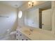 Bright bathroom featuring a large mirror, white cabinets, and a toilet at 4981 Millwood Dr, Canton, GA 30114