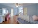 Bedroom with ceiling fan, wooden floors, and neutral paint. A dressing table with mirror is included at 4981 Millwood Dr, Canton, GA 30114