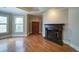 Bedroom featuring a fireplace, hardwood floors, and lots of natural light at 4981 Millwood Dr, Canton, GA 30114
