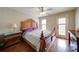 Spacious bedroom with a ceiling fan, a wooden bed frame, and natural light from the windows at 4981 Millwood Dr, Canton, GA 30114