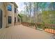 Expansive deck with a wood railing overlooking the lush green backyard and pool at 4981 Millwood Dr, Canton, GA 30114