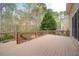 Large wooden deck with brown railing and lush backyard views at 4981 Millwood Dr, Canton, GA 30114