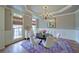 Bright dining room featuring hardwood floors, chandelier, and large windows allowing for ample natural light at 4981 Millwood Dr, Canton, GA 30114