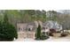 Charming two-story home featuring a two-car garage, covered porch, and well-maintained landscaping at 4981 Millwood Dr, Canton, GA 30114