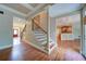 Entry foyer featuring hardwood floors, staircase, and views into the kitchen and front entry at 4981 Millwood Dr, Canton, GA 30114