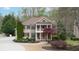 Charming two-story home with a welcoming front porch and manicured landscaping at 4981 Millwood Dr, Canton, GA 30114