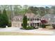 Elegant two-story home with a three-car garage and circular driveway at 4981 Millwood Dr, Canton, GA 30114