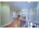 Hallway with hardwood floors and traditional wood and iron railing. Built-in shelving at 4981 Millwood Dr, Canton, GA 30114