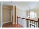 Upstairs hallway with hardwood floors, chandelier, and natural light at 4981 Millwood Dr, Canton, GA 30114