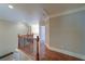 Hallway with hardwood floors and traditional wood and iron railing at 4981 Millwood Dr, Canton, GA 30114
