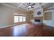 Open living room with trey ceilings, hardwood floors, fireplace, and built-in shelves at 4981 Millwood Dr, Canton, GA 30114