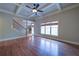 Living room with trey ceilings, hardwood floors, staircase, and large window with natural light at 4981 Millwood Dr, Canton, GA 30114