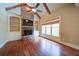 Cozy living room featuring a stone fireplace, built-in shelving, and exposed ceiling beams at 4981 Millwood Dr, Canton, GA 30114