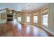 Spacious living room with hardwood floors, stone fireplace, and large windows with natural light at 4981 Millwood Dr, Canton, GA 30114