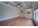 Bright living room featuring trey ceilings and hardwood floors open to the staircase and kitchen at 4981 Millwood Dr, Canton, GA 30114