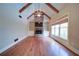 Open living room with hardwood floors, vaulted ceiling, and a stone fireplace and built-in shelves at 4981 Millwood Dr, Canton, GA 30114