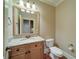 Powder room features granite counters, wood cabinets, toilet, and hardwood floors at 4981 Millwood Dr, Canton, GA 30114