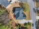 An aerial view showcases the home's expansive roof, lush landscaping, and spacious driveway at 2924 Meadow Church Rd, Suwanee, GA 30024