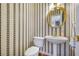 Half bathroom with pedestal sink and patterned wallpaper at 2924 Meadow Church Rd, Suwanee, GA 30024