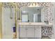 Well-lit bathroom featuring a large shower, double vanity, and patterned wallpaper at 2924 Meadow Church Rd, Suwanee, GA 30024