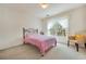 Bright bedroom with a twin bed, a window with sheer curtains, and a rattan chair at 2924 Meadow Church Rd, Suwanee, GA 30024