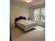 Comfortable bedroom featuring a twin bed with a decorative quilt and vintage furniture at 2924 Meadow Church Rd, Suwanee, GA 30024