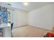 Cozy bedroom with neutral walls and carpet, featuring a large window at 2924 Meadow Church Rd, Suwanee, GA 30024