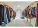 Spacious walk-in closet with ample hanging space and a central window for natural light at 2924 Meadow Church Rd, Suwanee, GA 30024