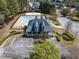 An aerial shot showcases the community pool and clubhouse surrounded by parking and green landscaping at 2924 Meadow Church Rd, Suwanee, GA 30024