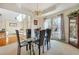 Elegant dining room featuring a modern glass table and natural light at 2924 Meadow Church Rd, Suwanee, GA 30024