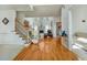 Grand foyer with hardwood floors, staircase, and open view to the living area at 2924 Meadow Church Rd, Suwanee, GA 30024