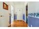 Entry hallway with hardwood floors and white doors at 2924 Meadow Church Rd, Suwanee, GA 30024