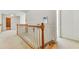Upstairs hallway with carpeted floors and wooden railing at 2924 Meadow Church Rd, Suwanee, GA 30024