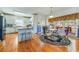 Bright kitchen features white cabinetry, stainless steel appliances, island with seating and adjacent breakfast nook at 2924 Meadow Church Rd, Suwanee, GA 30024