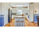 White kitchen with stainless steel appliances and island with bar stool seating at 2924 Meadow Church Rd, Suwanee, GA 30024