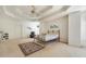 Large main bedroom featuring neutral carpet, tray ceiling, and arched window at 2924 Meadow Church Rd, Suwanee, GA 30024
