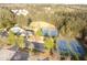 Community aerial showcasing a swimming pool and several tennis courts near lush trees at 3354 Preserve Run Trl, Loganville, GA 30052