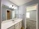 Bathroom featuring a vanity, mirror, and doorway view into the bedroom at 3354 Preserve Run Trl, Loganville, GA 30052