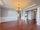 Elegant dining room with hardwood floors, chandelier, and classic wainscoting at 3354 Preserve Run Trl, Loganville, GA 30052