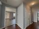 Entry hall with hardwood floors leads to the living room and bathroom at 3354 Preserve Run Trl, Loganville, GA 30052