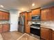 Bright kitchen features stainless steel appliances, granite countertops and beautiful tile flooring at 3354 Preserve Run Trl, Loganville, GA 30052