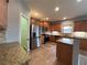 Spacious kitchen features stainless steel appliances, granite countertops, island, and tile flooring at 3354 Preserve Run Trl, Loganville, GA 30052
