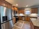 Open kitchen features stainless steel appliances, granite countertops, tile backsplash, and tile flooring at 3354 Preserve Run Trl, Loganville, GA 30052