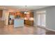 Well-lit kitchen featuring stainless steel appliances, wood cabinets, and tiled floors leading to French doors at 3354 Preserve Run Trl, Loganville, GA 30052
